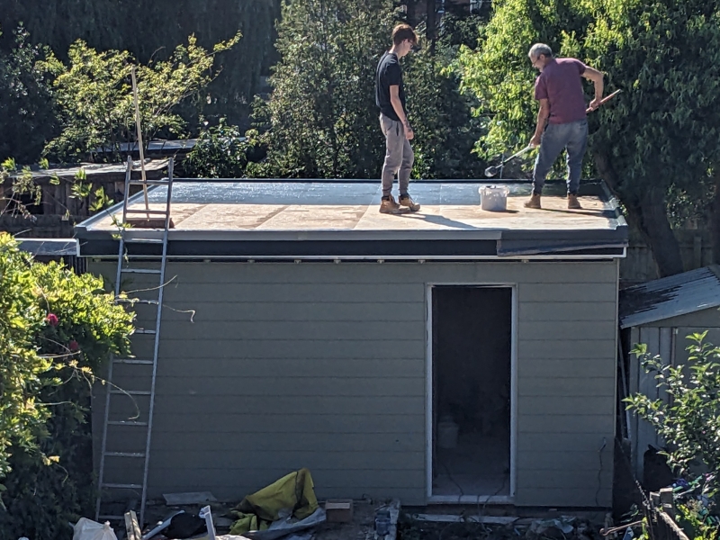Exterior view showing the roof being painted.